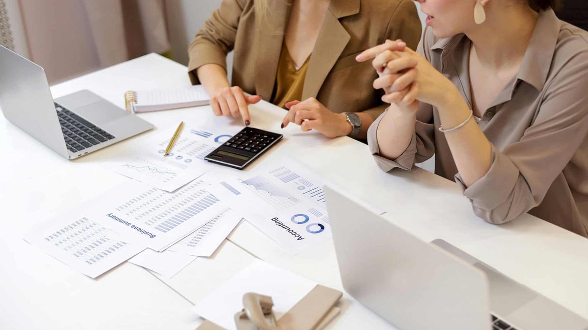 A business owner reviewing marketing quotes and SEO reports at a desk